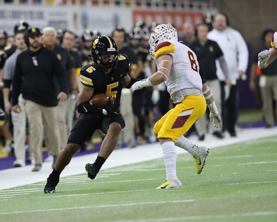 Ankeny Hawks Nick Eaton (8) eyes Southeast Polk Rams Xavier Nwankpa (5) after the catch at the UNI Dome.