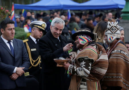 Bolivia's Vice President Alvaro Garcia Linera greets witchdoctors at a vigil, during a satellite transmission of Bolivia and Chile presenting their arguments at the World Court, in La Paz, Bolivia, March 19, 2018. REUTERS/David Mercado