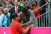 Head Coach Mike Krzyzewski of the USA Mens Senior National team talks to The First Lady Michelle Obama after defeating France 98-71 at the Olympic Park Basketball Arena during the London Olympic Games on July 29, 2012 in London, England. NOTE TO USER: User expressly acknowledges and agrees that, by downloading and/or using this Photograph, user is consenting to the terms and conditions of the Getty Images License Agreement. Mandatory Copyright Notice: Copyright 2012 NBAE (Photo by Jesse D. Garrabrant/NBAE via Getty Images)