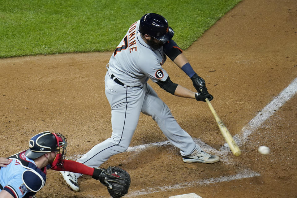 Detroit Tigers' Austin Romine hits an RBI single with the bases loaded off Minnesota Twins' pitcher Tyler Duffey in the sixth inning of a baseball game Tuesday, Sept. 22, 2020, in Minneapolis. (AP Photo/Jim Mone)