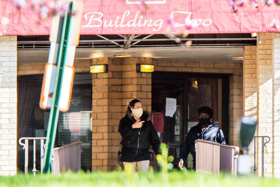 People exit Andover Subacute and Rehabilitation Center while wearing masks on April 16, 2020 in Andover, New Jersey