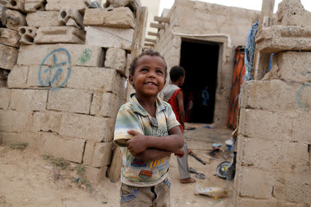 A boy displaced from the Red Sea port city of Hodeidah stands outside a host family house where he lives in an outskirt of Sanaa, Yemen July 10, 2018. REUTERS/Khaled Abdullah