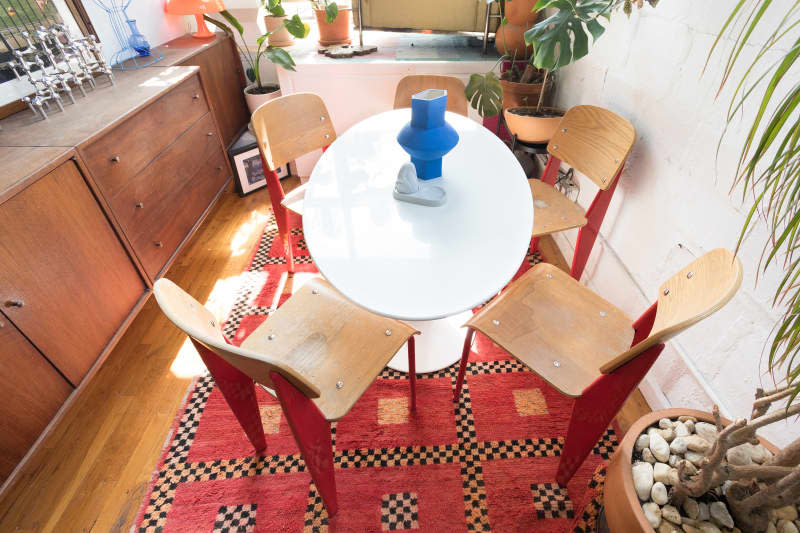 Wood chairs around white oval dining table.