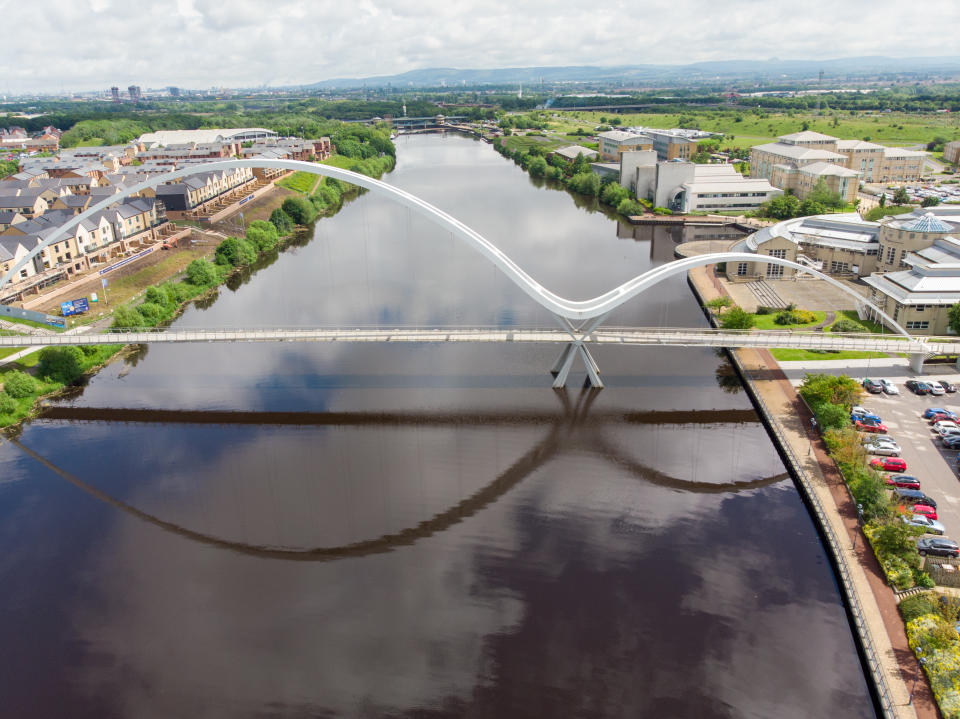 Aerial photo of The famous Infinity Bridge located in Stockton-on-Tees taken on a bright sunny part cloudy day.