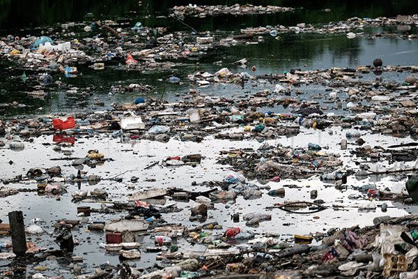 Debris floats at the Penha Canal that streams directly into the Guanabara Bay in Rio de Janeiro . Source: World of Sport