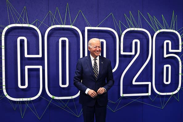 An image of President Joe Biden in front of a sign that says "COP26"