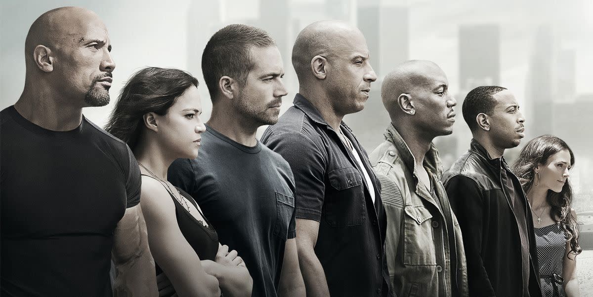 an image that features the stars of the fast and the furious franchise looking out into the distance it was used as a promotional image for furious 7