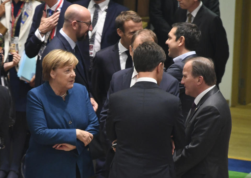 German Chancellor Angela Merkel, left, speaks with Swedish Prime Minister Stefan Lofven, right, and Dutch Prime Minister Mark Rutte, center, during a round table at an EU summit in Brussels, Wednesday, Oct. 17, 2018. European Union leaders are converging on Brussels for what had been billed as a "moment of truth" Brexit summit but which now holds little promise for a breakthrough. (Piroschka van de Wouw, Pool Photo via AP)