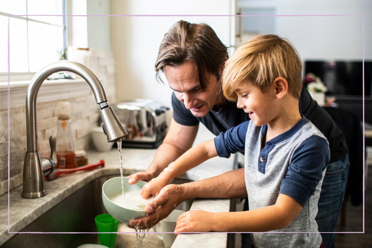  Father and son washing up together. 