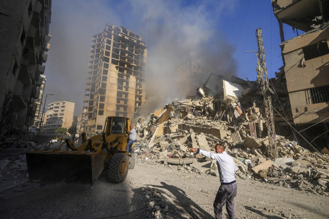 A bulldozer works at the site of an Israeli airstrike in Dahiyeh, Beirut, Lebanon, Thursday, Oct. 3, 2024. (AP Photo/Hassan Ammar)