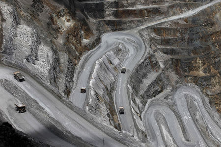 FILE PHOTO: Trucks operate in the open-pit mine of PT Freeport's Grasberg copper and gold mine complex near Timika, in the eastern region of Papua, Indonesia on September 19, 2015 in this photo taken by Antara Foto. REUTERS/Muhammad Adimaja/Antara Foto/File Photo