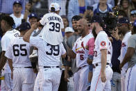 National League's Albert Pujols, of the St. Louis Cardinals, (5) is greeted by fellow players during the MLB All-Star baseball Home Run Derby, Monday, July 18, 2022, in Los Angeles. (AP Photo/Jae C. Hong)