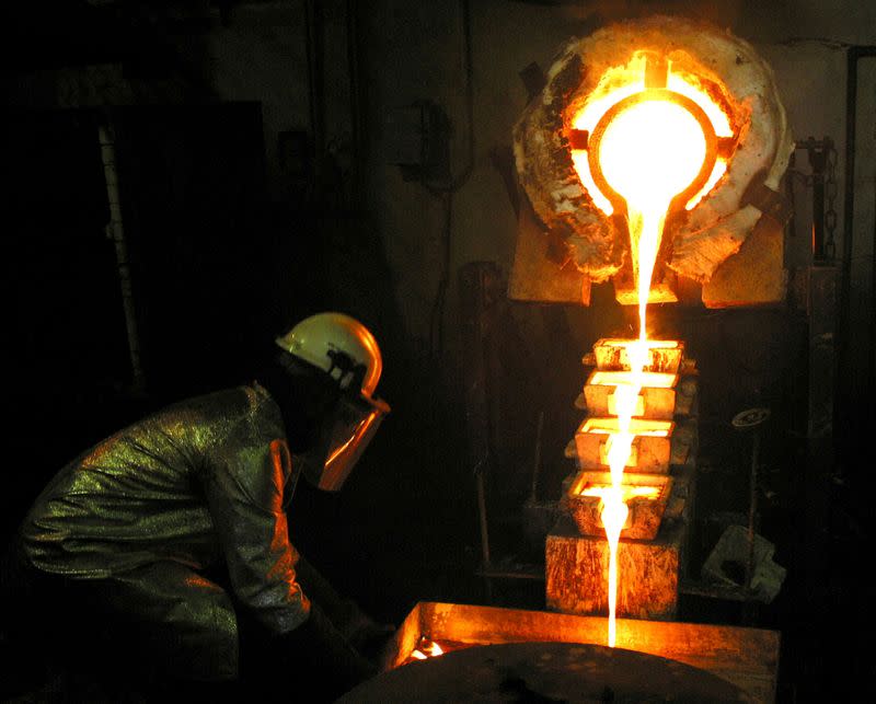 FILE PHOTO: A worker pours gold at the AngloGold Ashanti mine at Obuasi, Ghana