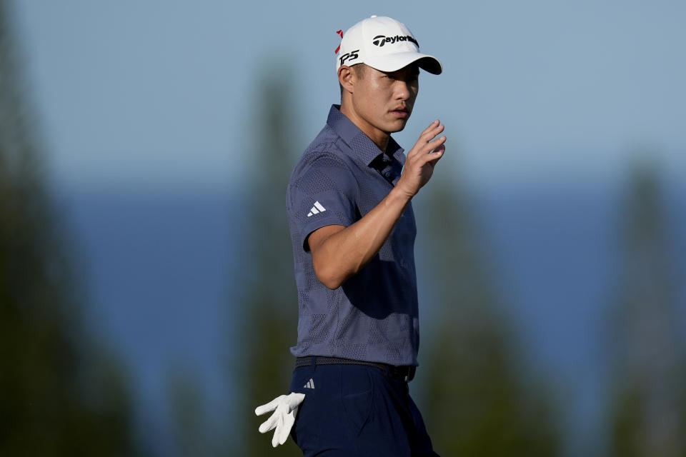Collin Morikawa acknowledges the gallery on the third green during the first round of The Sentry golf event, Thursday, Jan. 4, 2024, at Kapalua Plantation Course in Kapalua, Hawaii. (AP Photo/Matt York)