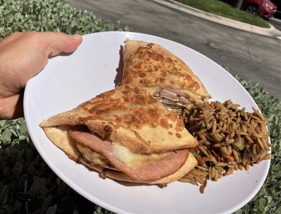 The chicken cordon bleu sandwich (with a side of orzo pasta) at Cafe Sole in Jupiter features grilled chicken, thinly sliced ham, melted Swiss cheese and honey mustard.