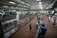 The assembly room is almost empty at the Santa Teresa rum factory while under 10 percent of workers are on duty, due to the new coronavirus in La Victoria, Aragua state, Venezuela, Wednesday, April 1, 2020. Venezuela's premier rum distillery and one of Venezuela's few private businesses says that most of its production will be for antiseptic alcohol, in an effort to help contain the spread of COVID-19. (AP Photo/Ariana Cubillos)