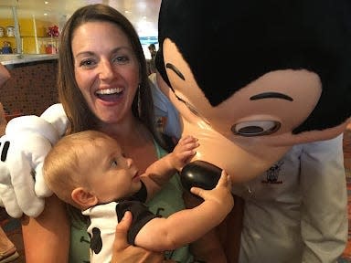 tarah and her child with mickey mouse at chef mickey's restaurant