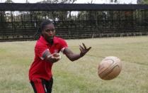 Kenya Women's Rugby team player Janet Okello passes the ball during a light training session at the RFUEA grounds in the capital Nairobi, April 4, 2016. REUTERS/Thomas Mukoya