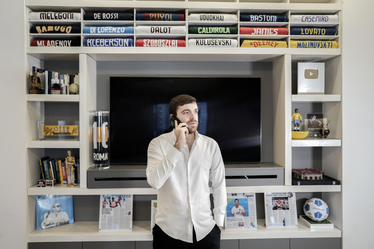 Fabrizio Romano, uno de los periodistas de fichajes más reconocidos del fútbol, junto a camisetas y premios en su casa en Milán, Italia, el 24 de enero de 2022. (Alessandro Grassani/The New York Times).