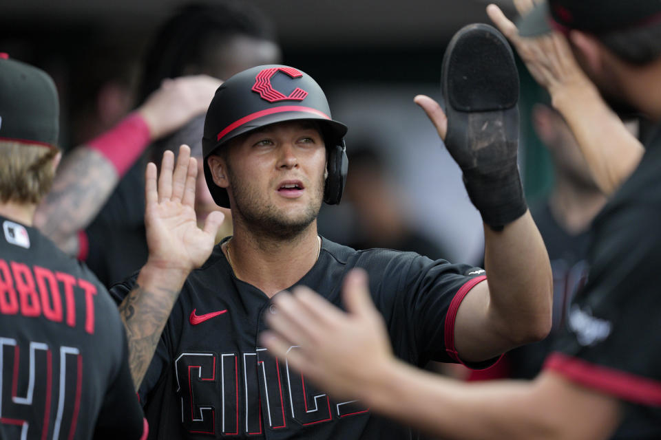 Cincinnati Reds' Nick Senzel, center, celebrates with teammates after scoring on a fielder's choice hit into by Spencer Steer during the first inning of a baseball game against the Arizona Diamondbacks, Friday, July 21, 2023, in Cincinnati. (AP Photo/Jeff Dean)
