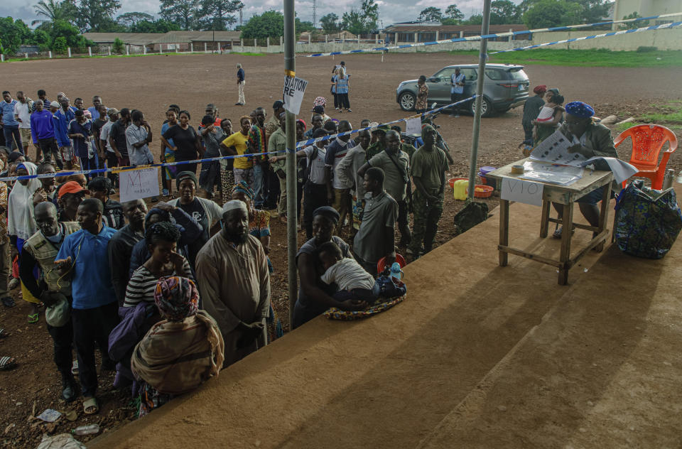 Voters wait for polling stations to open in Sierra Leone general elections in Freetown Saturday June 24, 2023. Sierra Leoneans are selecting their next president amid mounting frustration due to an ailing economy, rising unemployment and the loom of deadly protests. (AP Photo/TJ Bade)