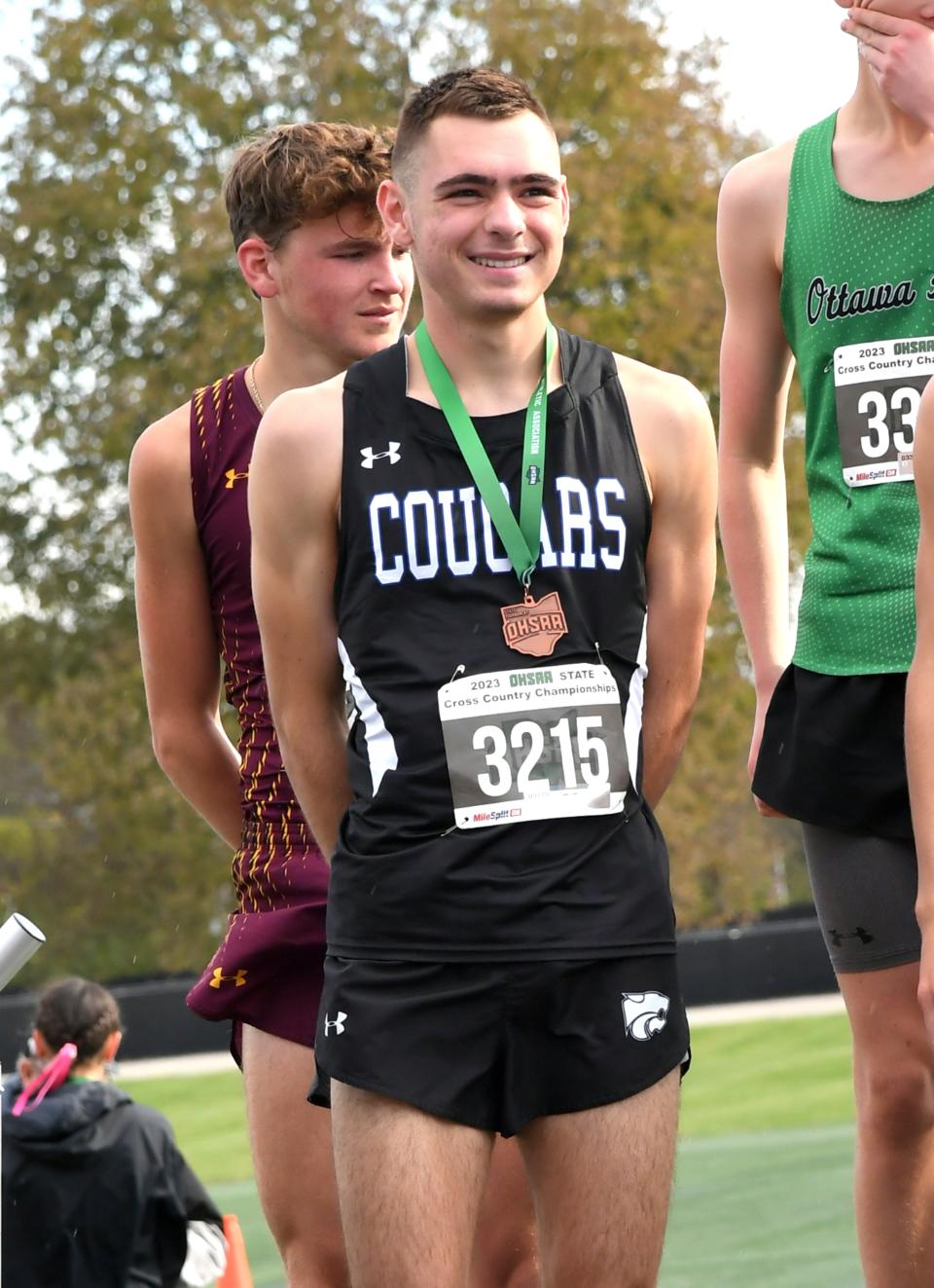 Micah Katz of Cincinnati Christian receives his top 20 medal in the boys Division III race at the OHSAA State Cross Country Championships, Fortress Obetz, Ohio, Nov. 4, 2023.