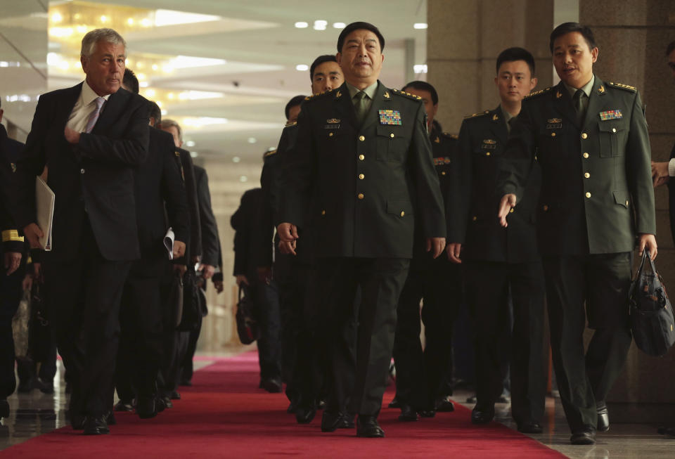 U.S. Defense Secretary Chuck Hagel, left, and Chinese Defense Minister Chang Wanquan, center, arrive at a joint news conference at the Chinese Defense Ministry headquarters in Beijing, China Tuesday, April 8, 2014. The defense chiefs of China and the U.S. faced off Tuesday over Beijing's escalating territorial disputes in the region, as Hagel, wagging his finger, said China doesn't have the right to unilaterally establish an air defense zone over disputed islands with no consultation. (AP Photo/Alex Wong, Pool)