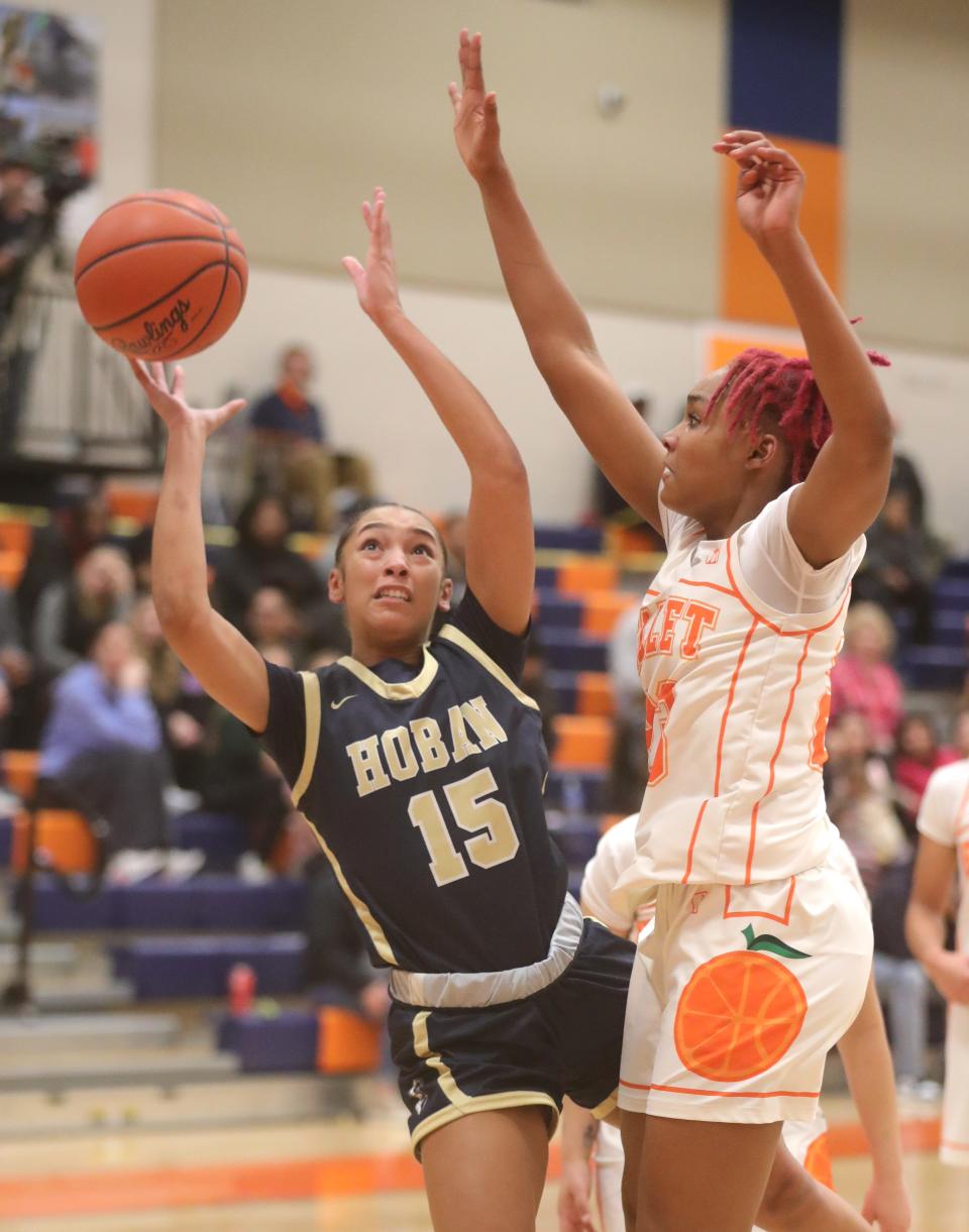 Hoban's Mackenzie Edingburgh puts up a shot as Ellet's Sanaiiya Gray defends Dec. 13 in Akron.