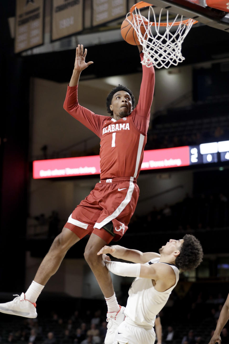 Alabama forward Herbert Jones (1) scores over Vanderbilt guard Scotty Pippen Jr. in the second half of an NCAA college basketball game Wednesday, Jan. 22, 2020, in Nashville, Tenn. (AP Photo/Mark Humphrey)