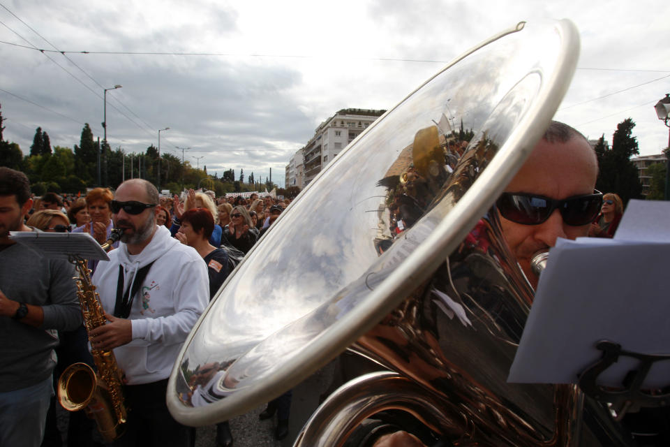 Members of Athens municipal brass band play their instruments during a demonstration by municipal employees on Tuesday, Nov. 20, 2012. About 2,000 people took part in the protest, against government plans to place 2,000 civil servants on notice ahead of reassignment or potential dismissal. Greece faces a tense wait Tuesday for vital bailout money as finance ministers from the 17 European Union countries that use the euro try to reach an agreement on how to put the country's economic recovery back on the right track. (AP Photo/Thanassis Stavrakis)