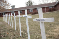 FILE - In this Dec. 8, 2020 file photo, white crosses on the lawn of Good Samaritan Society nursing home in Canton, S.D., commemorate residents who have died in recent weeks from the coronavirus. (AP Photo/Stephen Groves)