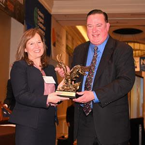 Minuteman Press Westfield franchise owner Jim Mooney accepts the Small Business of the Year Award from Elizabeth Manzo, Chairperson of the Gateway Regional Chamber of Commerce.