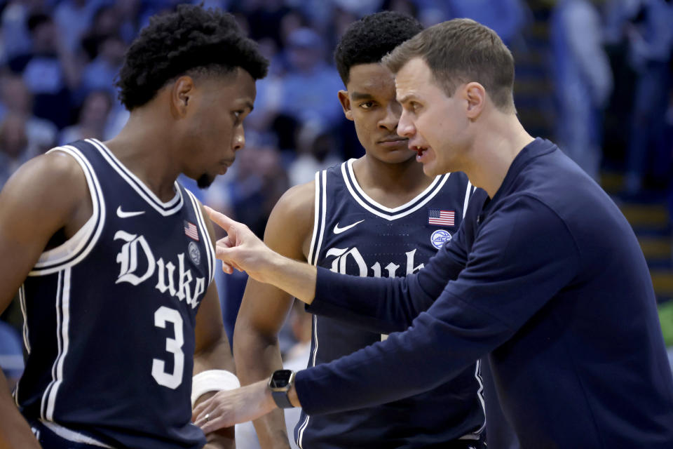 Duke head coach Jon Scheyer, right, gives direction to guards Jeremy Roach (3) and Caleb Foster, center, during the second half of an NCAA college basketball game against Duke Saturday, Feb. 3, 2024, in Chapel Hill, N.C. (AP Photo/Chris Seward)
