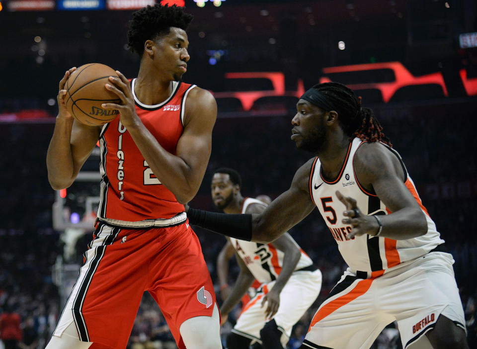 November 7, 2019; Los Angeles, CA, USA; Portland Trail Blazers center Hassan Whiteside (21) controls the ball against Los Angeles Clippers forward Montrezl Harrell (5) during the second half at Staples Center. Mandatory Credit: Gary A. Vasquez-USA TODAY Sports