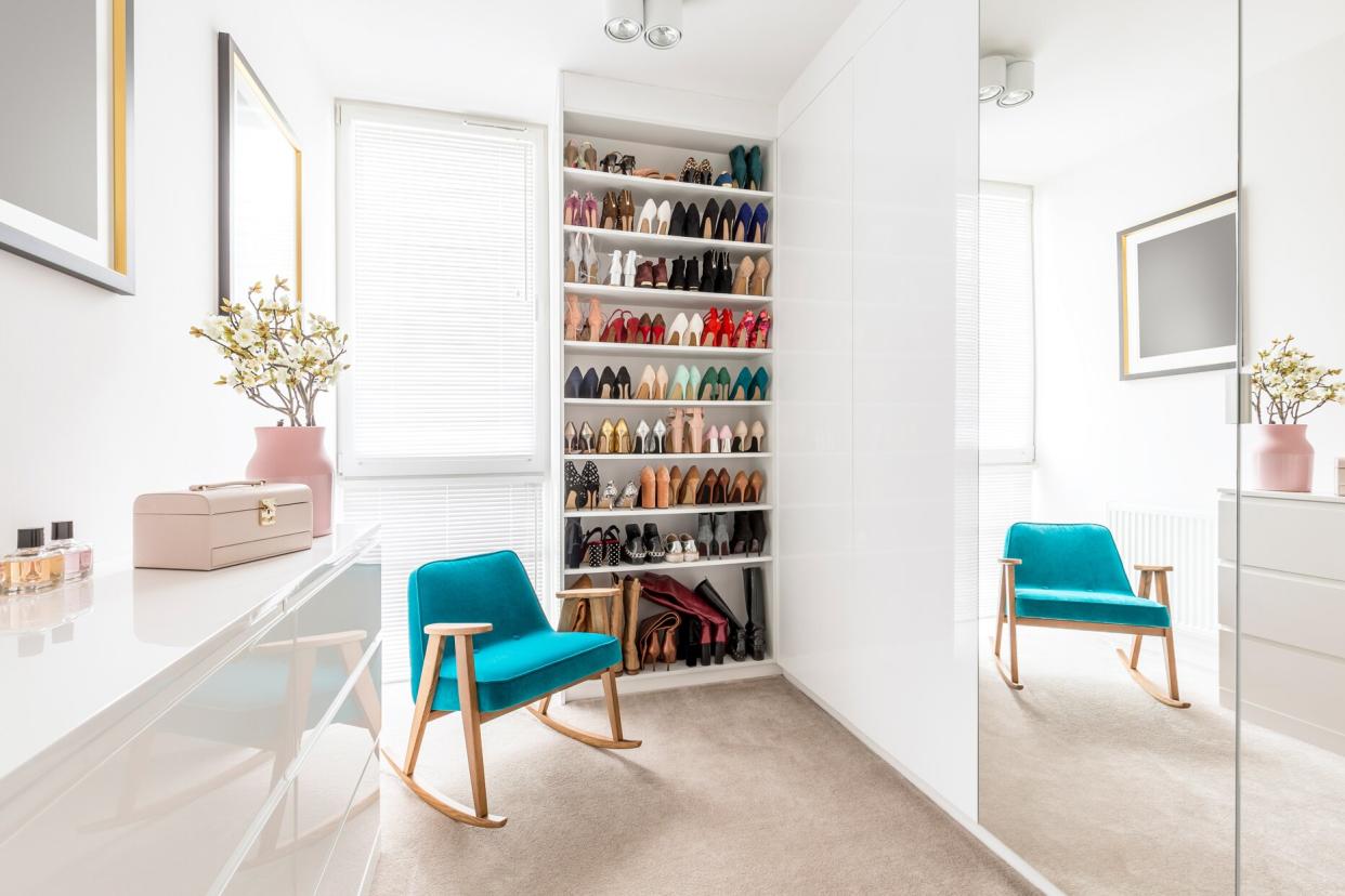 blue rocking chair beside shoe closet