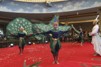 Cambodian dancers perform for passengers from the cruise ship Westerdam at a hotel in Phnom Penh, Cambodia, Wednesday, Feb. 19, 2020. Cambodian authority invited the passengers to entertain them. Having finally reached a friendly port willing to accept them and stepped ashore after weeks of uncertainty at sea, hundreds of the cruise ship passengers eyed warily over fears of a new virus are now simply trying to find a way home. (AP Photo/Heng Sinith)