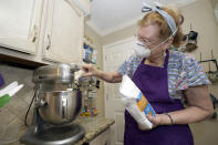 Julie Muller, who sells cookie decorating kits on Etsy, mixes up cookie dough Tuesday, Sept. 22, 2020, in Houston. One of the cookie-decorating kits she offers has a Black Lives Matter theme. Amid all the Black Lives Matter themed T-shirts, face masks and signs appearing in recent months, some unconventional merchandise has been popping up on online crafts marketplace Etsy. (AP Photo/David J. Phillip)