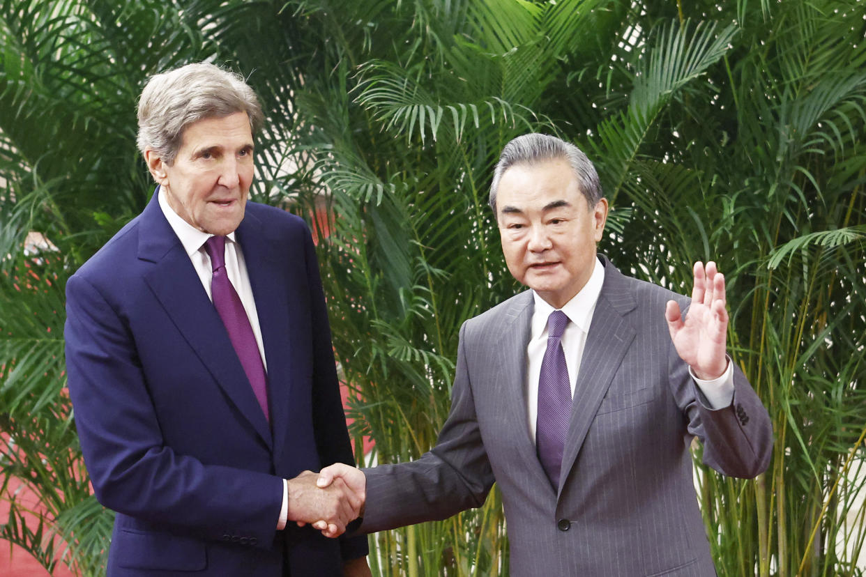 U.S. climate envoy John Kerry (L) is greeted by top Chinese diplomat Wang Yi before a meeting in the Great Hall of the People on July 18, 2023 in Beijing, China. Kerry is in Beijing to restart climate negotiations between the world's two biggest polluters, which together account for nearly 40 percent of global emissions. Last year, China cut off climate talks in protest of then-U.S. House Speaker Nancy Pelosi's vist to Taiwan. (Florence Lo / Pool via Getty Images)