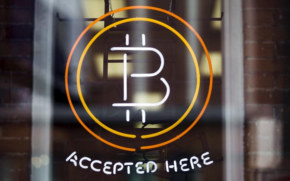 A Bitcoin sign: the cryptocurrency is not widely accepted as legal tender, and that makes it harder to determine its value than other currencies - Reuters