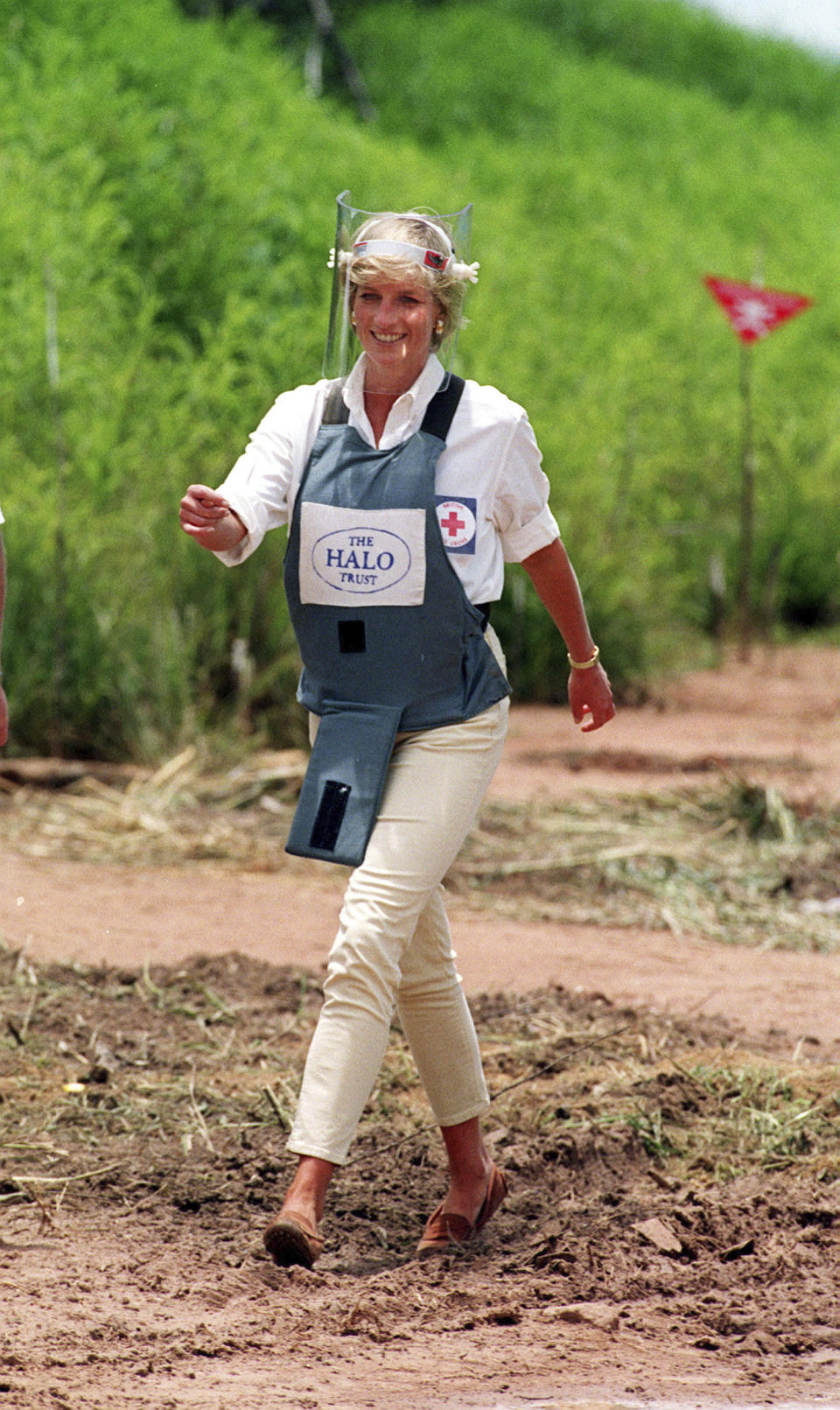 FILE - In this Jan. 15, 1997 file photo, Princess Diana, wearing a bombproof visor, visits a minefield in Huambo, in Angola. Prince Harry on Friday Sept. 27, 2019, is following in the footsteps of his late mother, Princess Diana, whose walk through an active mine field in Angola years ago helped to lead to a global ban on the deadly weapons. (John Stillwell/PA via AP, File)