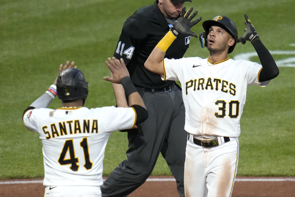 Pittsburgh Pirates' Tucupita Marcano (30) celebrates as he crosses home plate after hitting a grand slam home run off Texas Rangers relief pitcher Joe Barlow during the seventh inning of a baseball game in Pittsburgh, Monday, May 22, 2023. (AP Photo/Gene J. Puskar)