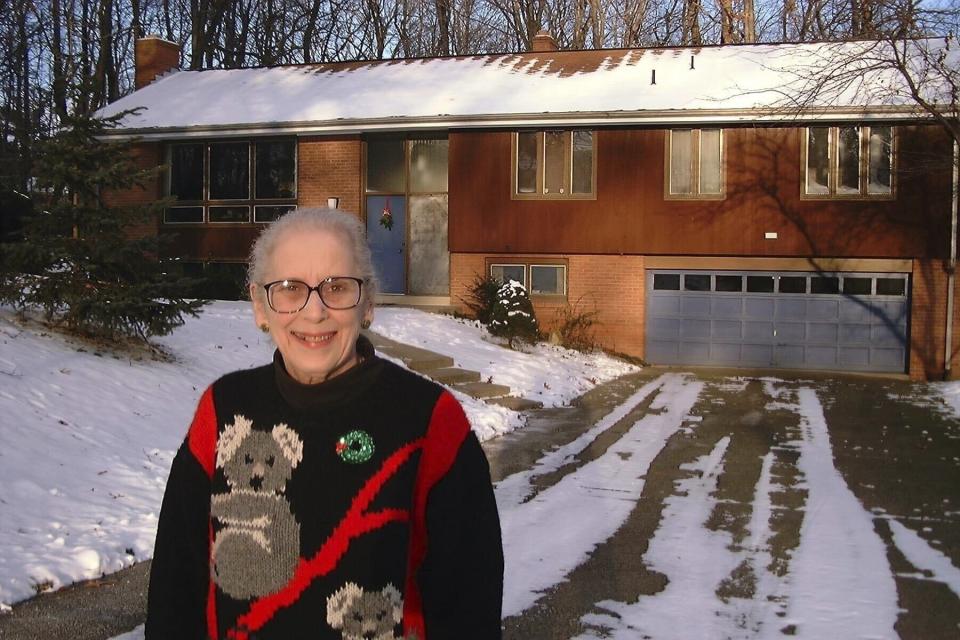 FILE - Ann T. Anthony poses for a photo on Dec, 26, 1998 in front of her home in Allison Park, Pa. (AP Photo/Ted Anthony, File)