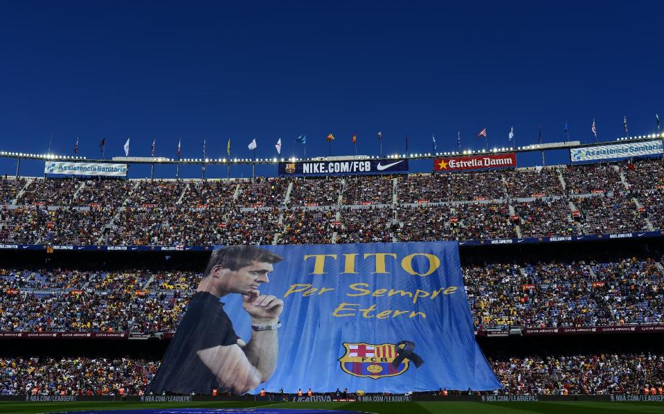A banner is displayed reading in Catalan: "Tito forever eternal" in honor for late former FC Barcelona's coach Tito Vilanova prior to the Spanish La Liga soccer match between FC Barcelona and Getafe at the Camp Nou stadium in Barcelona, Spain, Saturday, May 3, 2014. FC Barcelona announced on their web page Friday April 25, 2014, that Vilanova had died following a long battle with throat cancer. He was 45. (AP Photo/Manu Fernandez)