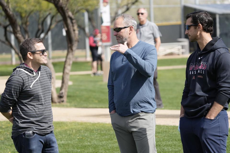 Diamondbacks senior vice-president & assistant general manager Amiel Sawdaye (left), manager Torey Lovullo (center), and general manager Mike Hazen talk during a workout on Feb. 21, 2022, for minor-league players not covered by the Players Association at Salt River Fields.