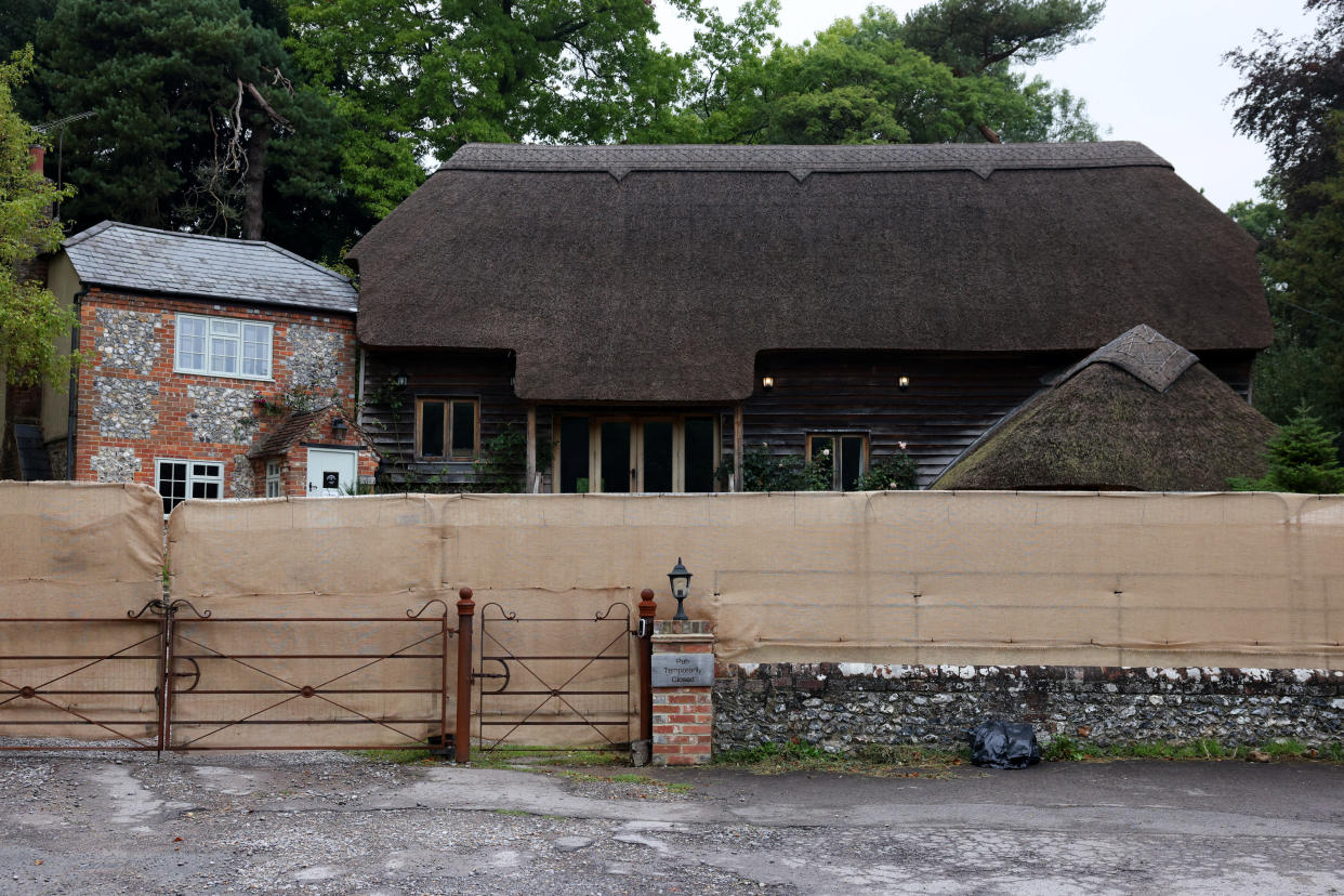 The Crown Inn pub owned by British comedian and actor Russell Brand's company is surrounded by a temporary screen. (Reuters/Hollie Adams)