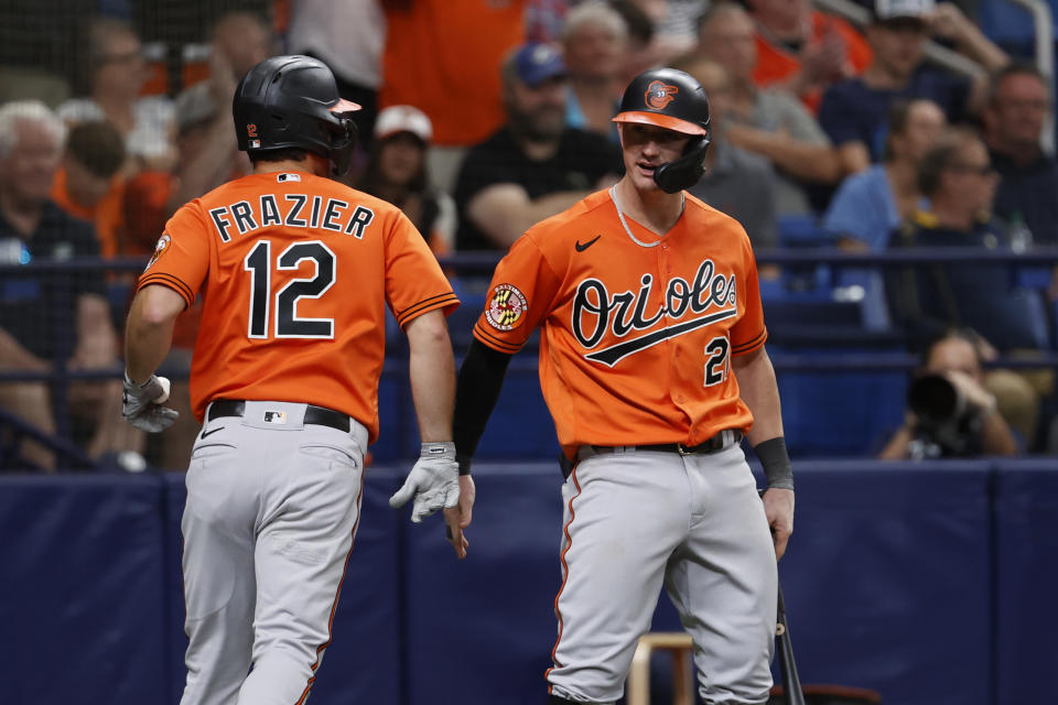 Baltimore Orioles' Adam Frazier (12) celebrates with teammate Austin Hays after scoring against the Tampa Bay Rays during the ninth inning of a baseball game Saturday, July 22, 2023, in St. Petersburg, Fla. (AP Photo/Scott Audette)