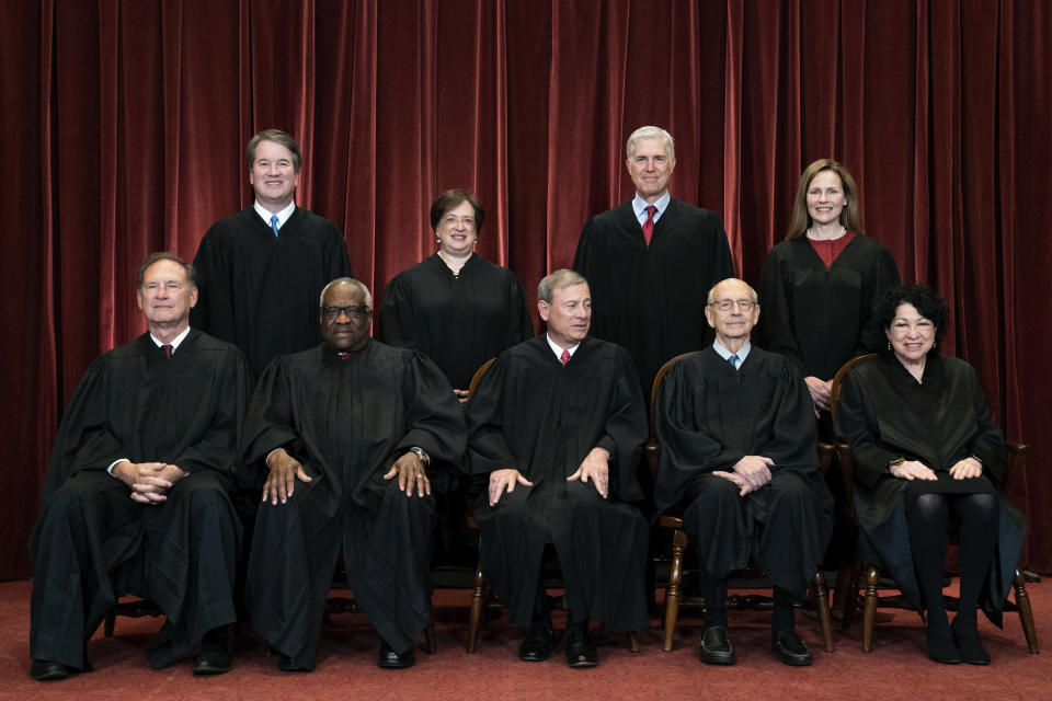 FILE - In this April 23, 2021, file photo, members of the Supreme Court pose for a group photo at the Supreme Court in Washington. Seated from left are Associate Justice Samuel Alito, Associate Justice Clarence Thomas, Chief Justice John Roberts, Associate Justice Stephen Breyer and Associate Justice Sonia Sotomayor, while standing from left are Associate Justice Brett Kavanaugh, Associate Justice Elena Kagan, Associate Justice Neil Gorsuch and Associate Justice Amy Coney Barrett. (Erin Schaff/The New York Times via AP, Pool, File)