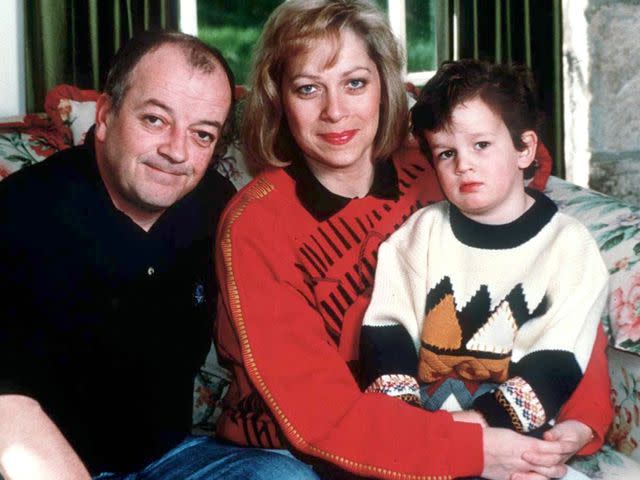 <p>Shutterstock</p> Tim Healy, Denise Welch and their son Matty Healy at home in 1997.