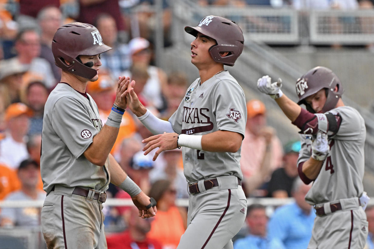 Texas A&M's Ali Camarillo (center) celebrates after scoring a run in the third inning against Tennessee during Game 1 of the College World Series finals on Sauturday at Charles Schwab Field in Omaha, Nebraska. (Photo by Peter Aiken/Getty Images)