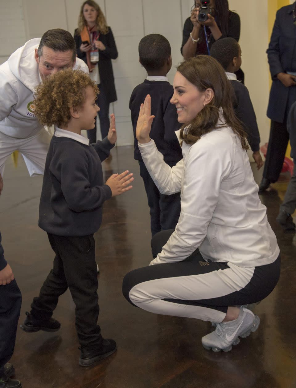 Kate high fived a curly-haired child at the school. Photo: Getty Images